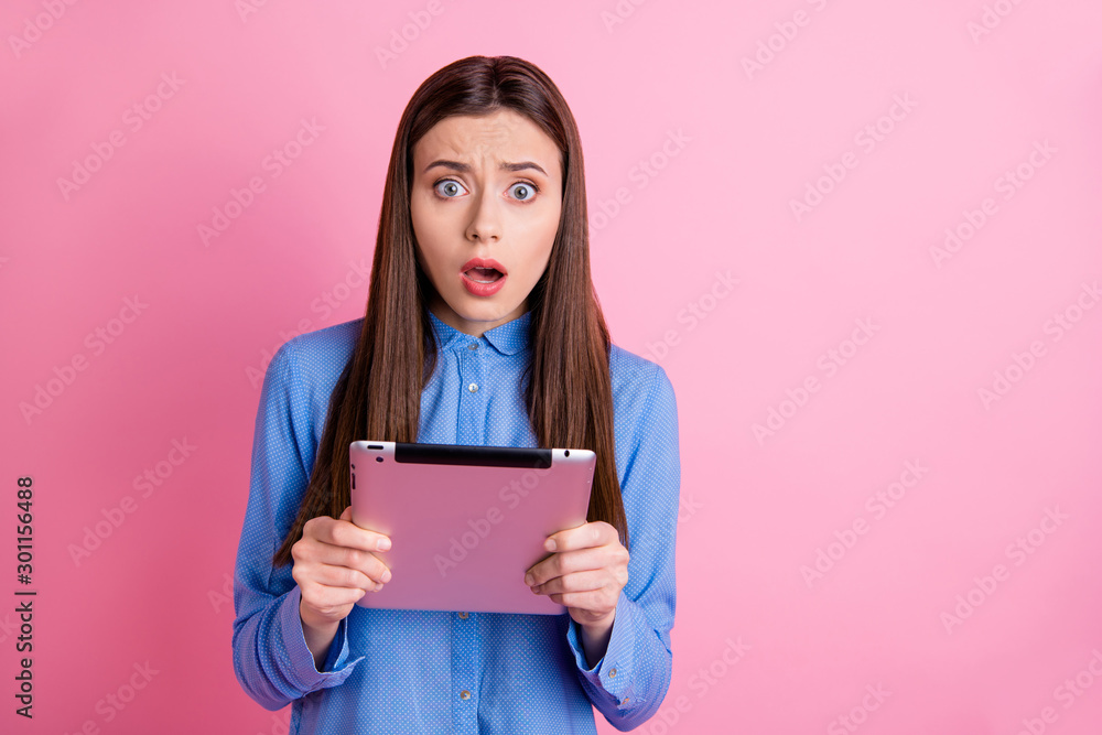 Photo of beautiful disappointed dissatisfied sweet attractive influencing blogger receiving negative comments holding tablet with hands wearing blue shirt isolated pink pastel color background Photo of beautiful disappointed dissatisfied sweet attractive influencing blogger receiving negative comments holding tablet with hands wearing blue shirt isolated pink pastel color background