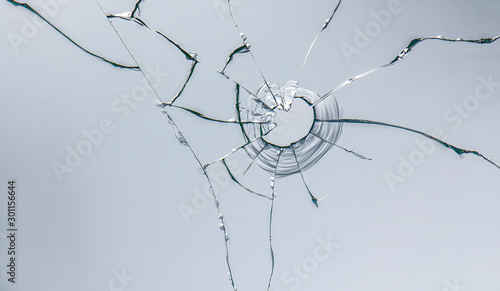 glass crack after window destruction on soft blue background