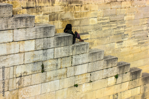 Lonely girl sits on the steps, India