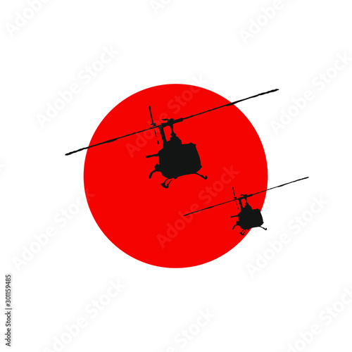 Helicopters UH-1 Huey against the setting sun.
