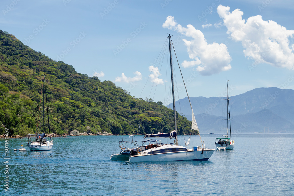 Catamaran Sailboat in Angra dos Reis Bay with the Mata Atlantica forest in the background.