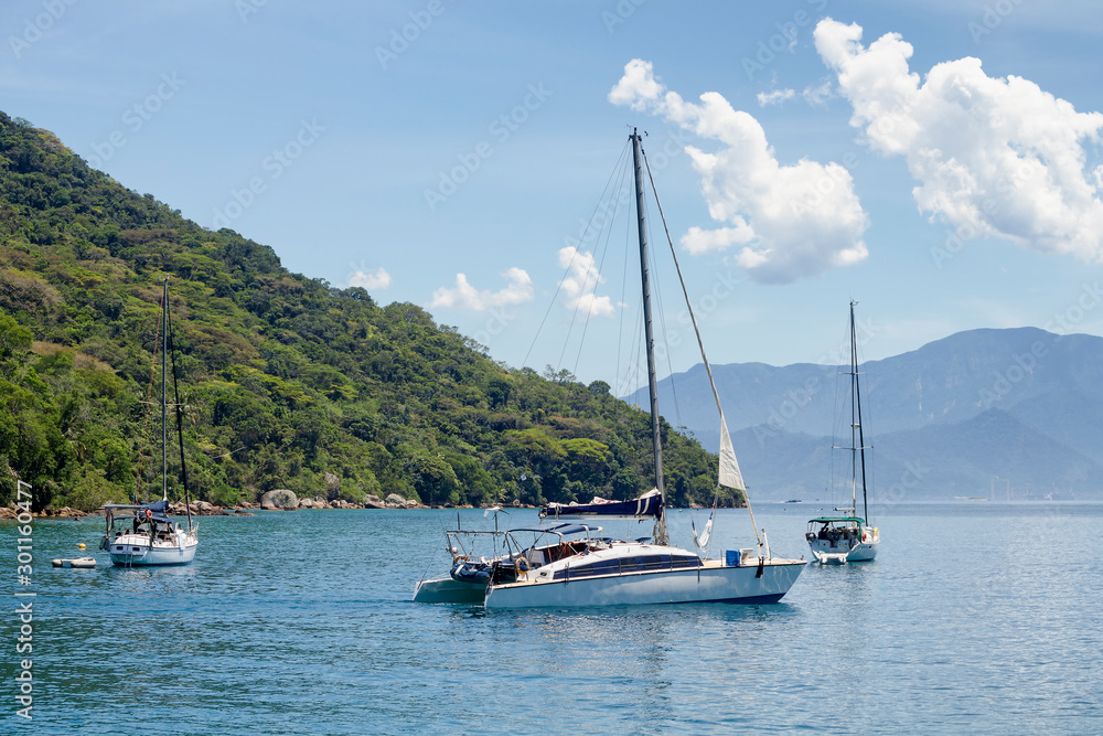 Catamaran Sailboat in Angra dos Reis Bay with the Mata Atlantica forest in the background. Catamaran Sailboat in Angra dos Reis Bay with the Mata Atlantica forest in the background.