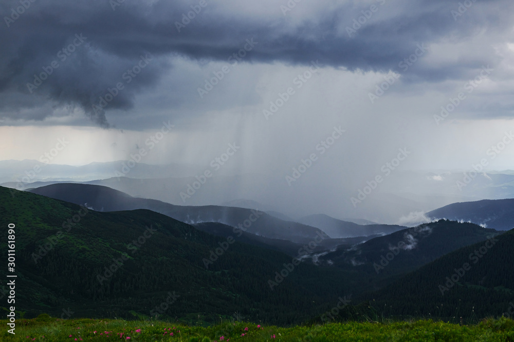 Rain falls far away. Majestic Carpathian mountains. Beautiful landscape. Breathtaking view