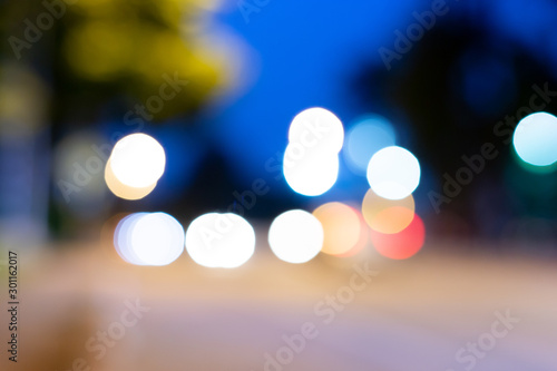 Blurry images, blurry images, cars on the roads that run in opposite directions, and the light reflected in beautiful bokeh. © Puwasit Inyavileart