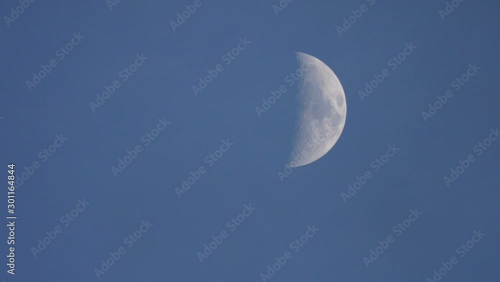 Cresent Moon In Blue Sky Day, Clouds Moving Across, Right Of Frame. Cresent Moon In Blue Sky Day, Clouds Moving Across, Right Of Frame.