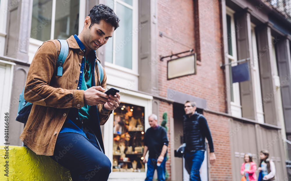 Happy man using smartphone on urban background Happy man using smartphone on urban background