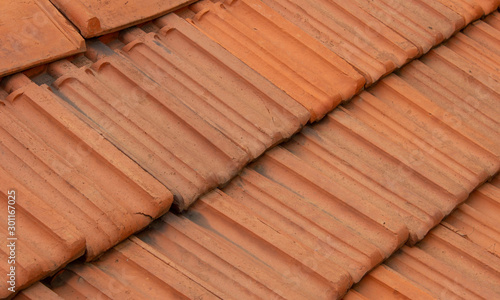 Roof top tiles arranged in interlocked position on a residential house
