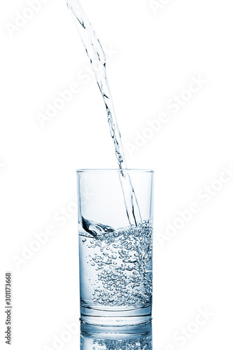 Pouring clean drinking water on a transparent glass. For health concepts. Isolated white background