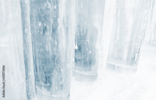 Thick pillars of blue ice recede into the background making an abstract pattern