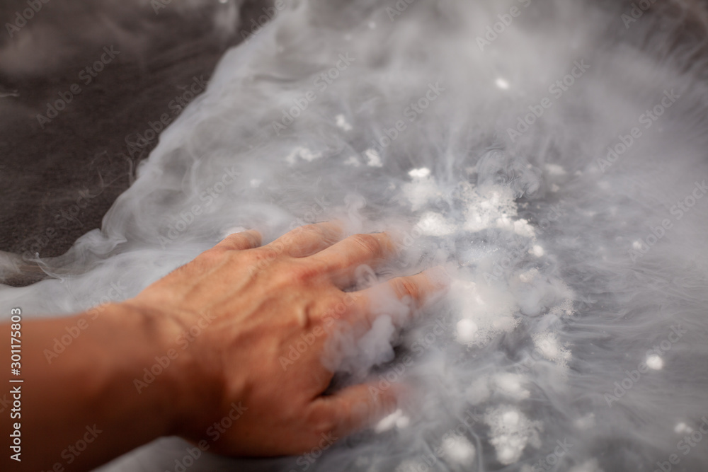 Thick white smoke on a background of black ceramic tiles. Thick white smoke on a background of black ceramic tiles.