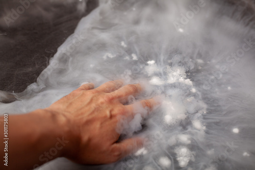 Thick white smoke on a background of black ceramic tiles.