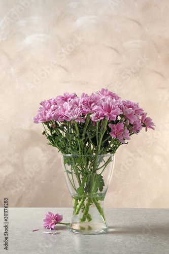 Wallpaper Mural Beautiful chrysanthemum flowers in glass vase on table Torontodigital.ca