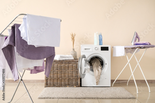 Wallpaper Mural Modern washing machine with laundry, clothes dryer and ironing board near color