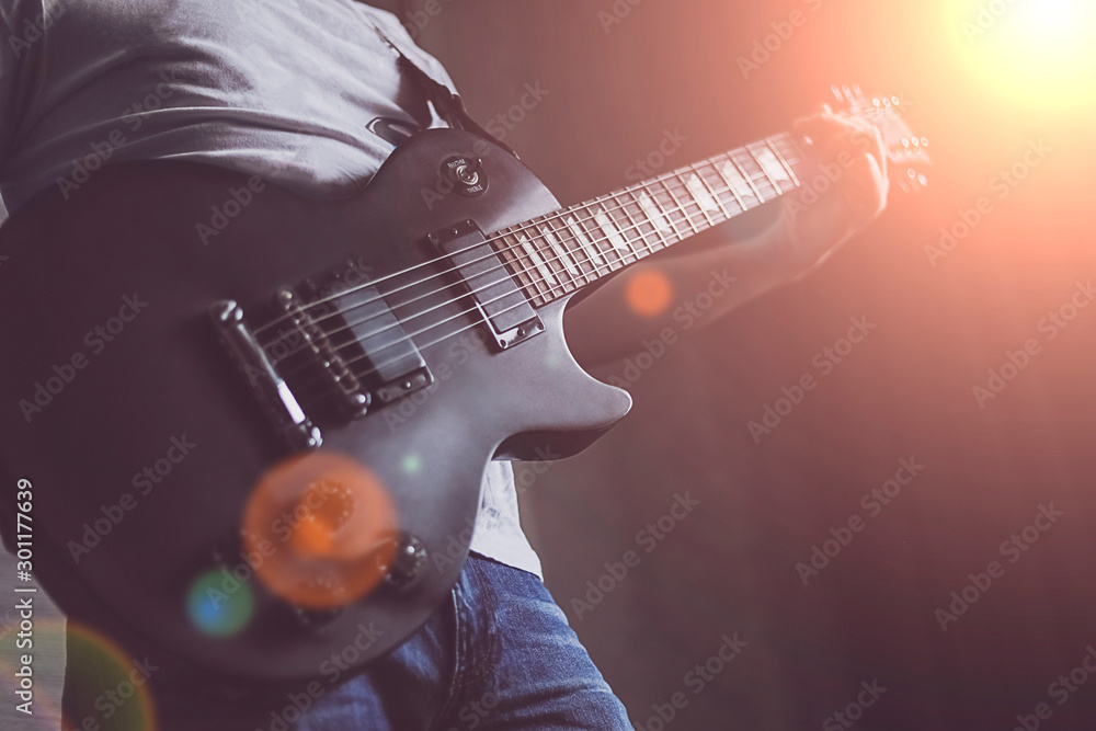 Obraz premium boy playing music on guitar, closeup