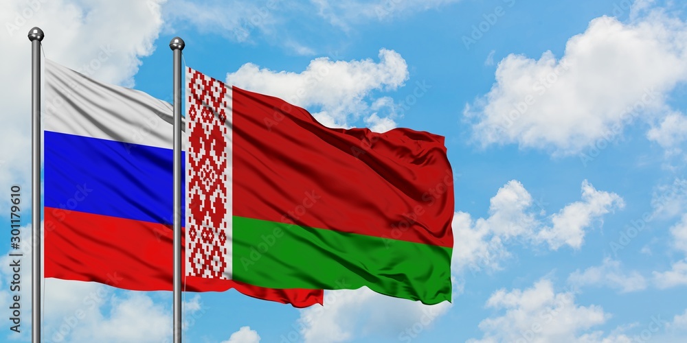 Obraz na płótnie Russia and Belarus flag waving in the wind against white cloudy blue sky together. Diplomacy concept, international relations. w salonie