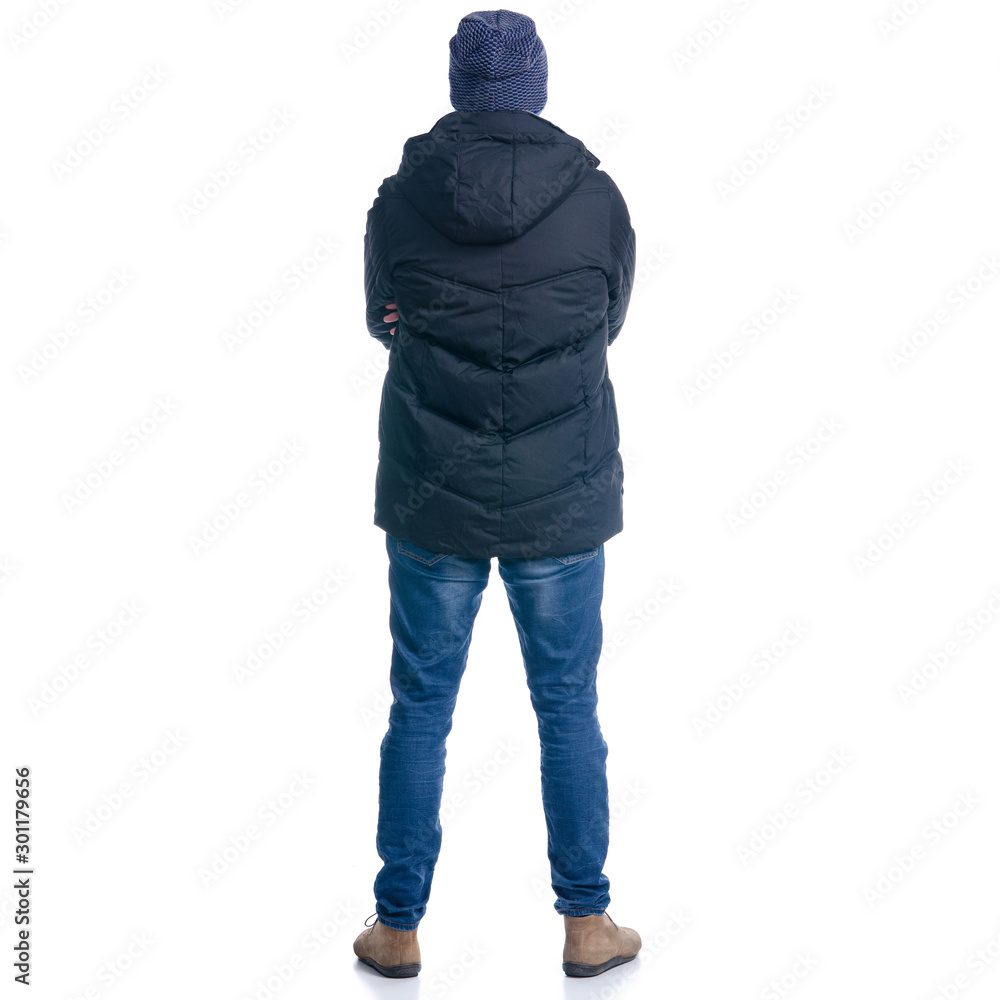 Man in winter jacket and warm hat standing looking Man in winter jacket and warm hat standing looking