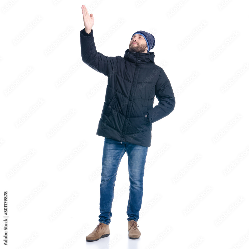 Man in winter jacket standing, looking, showing Man in winter jacket standing, looking, showing