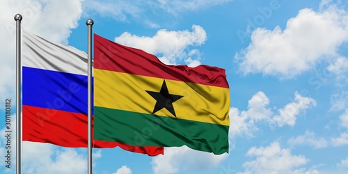 Canvas Print Russia and Ghana flag waving in the wind against white cloudy blue sky together