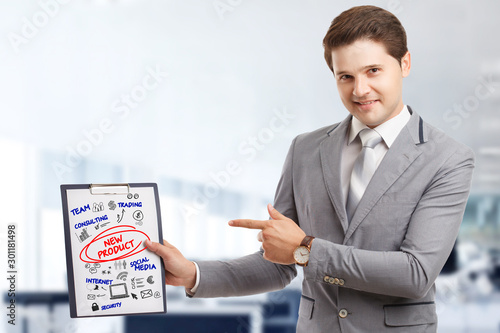 Wallpaper Mural Planning marketing strategy. Business, Technology, Internet and network concept. Young businessman shows the word: New product Torontodigital.ca