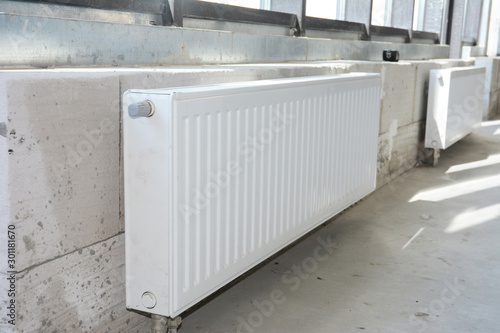 House radiator heating. Installing radiator heating at home. White metal radiators heating.