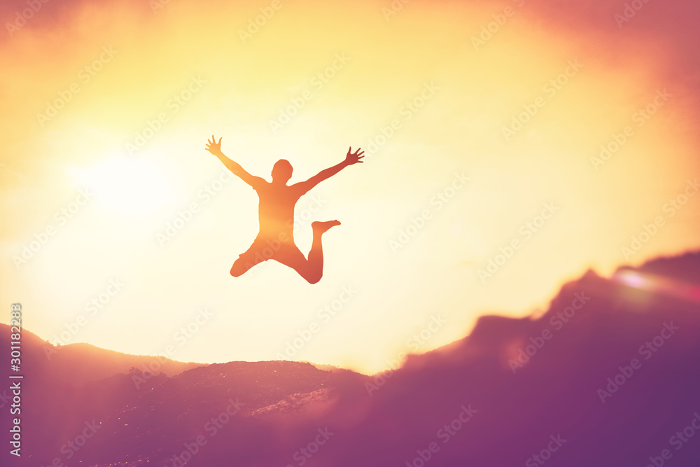 Happy man jumping at top of mountain with sunset sky abstract background. Happy man jumping at top of mountain with sunset sky abstract background.