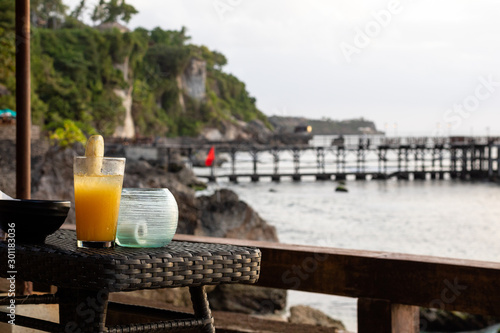 A tropical coktail waiting on a table with a sea view