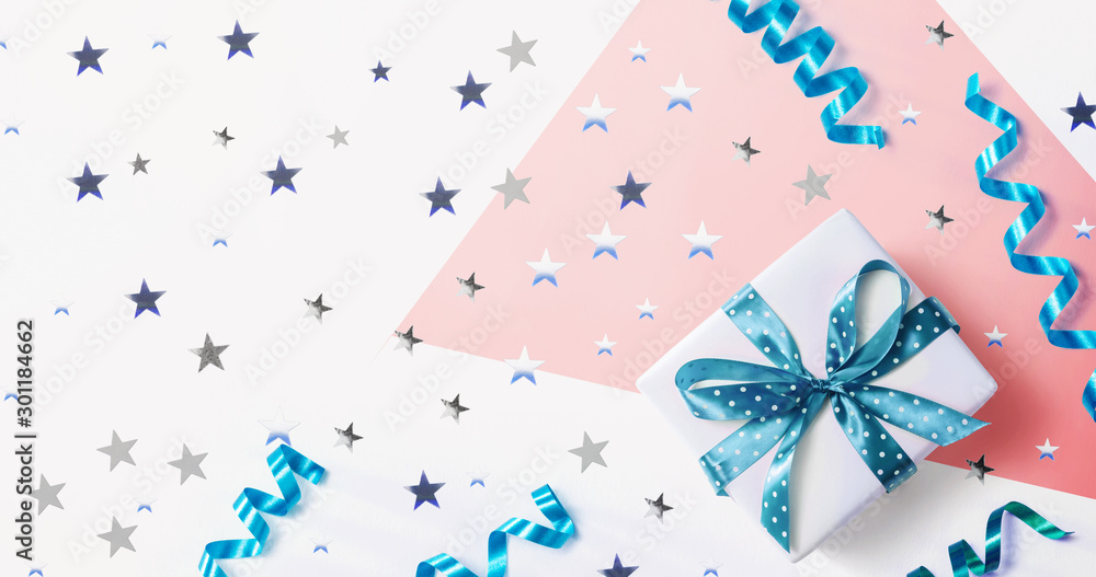 Fototapeta premium Gift box with confetti and ribbons - overhead view flat lay