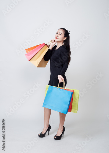 Woman With Shopping Bags Standing On White