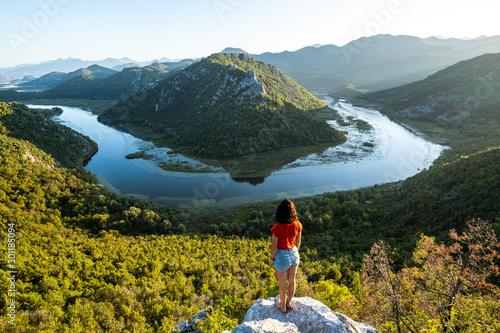 Lady looking over Lake Skadar in Montenegro during a beautiful sunset 
