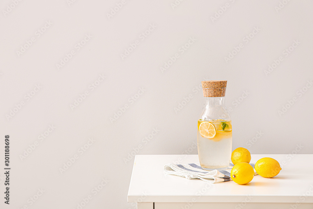 Bottle of cold lemonade on white table - obrazy, fototapety, plakaty 