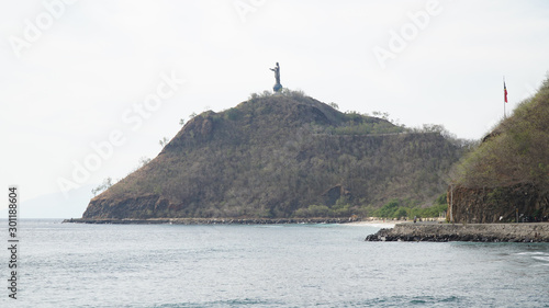 Cristo Rei Statue of Jesus at the beach on a hill at Cape Fatucama in Dili, East Timor. photo