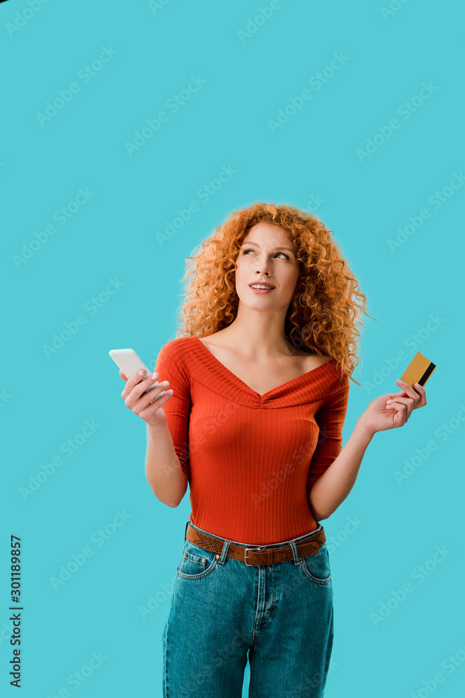 pensive woman shopping online with digital tablet and credit card isolated on blue pensive woman shopping online with digital tablet and credit card isolated on blue