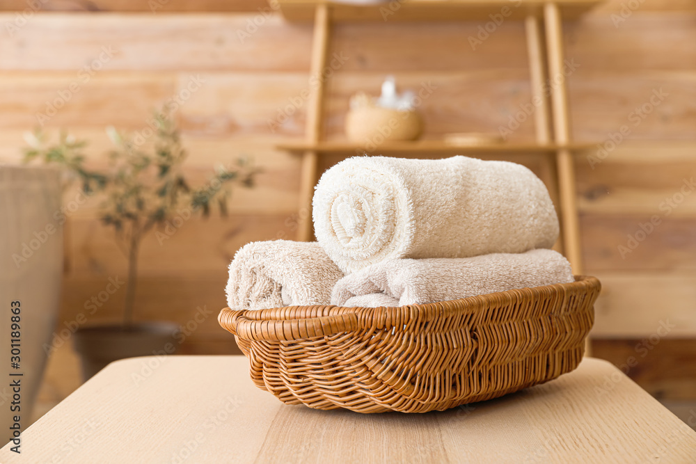 Basket with clean towels on table in bathroom Basket with clean towels on table in bathroom
