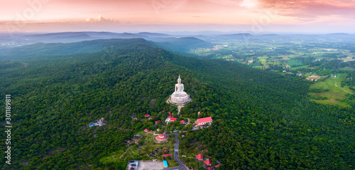 Top view Aerial photo from flying drone.Big Buddha Wat Phu Manorom Mukdahan Thailand.Buddha on the mountain. photo