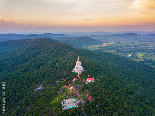 Top view Aerial photo from flying drone.Big Buddha Wat Phu Manorom Mukdahan Thailand.Buddha on the mountain.