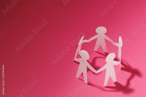 Obraz na płótnie Paper cut Style concept of a leader and relationship with friendship and hand-ho