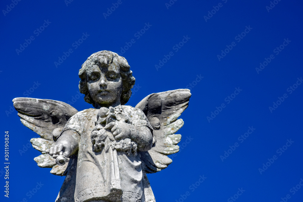 Statue of an angel at a cemetery, concept of death and loss during the pandemic.