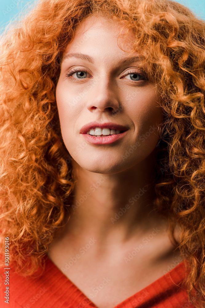portrait of beautiful smiling redhead woman isolated on blue portrait of beautiful smiling redhead woman isolated on blue