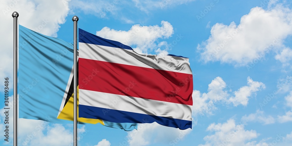 Saint Lucia and Costa Rica flag waving in the wind against white cloudy blue sky together. Diplomacy concept, international relations.