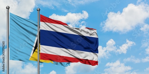 Saint Lucia and Thailand flag waving in the wind against white cloudy blue sky together. Diplomacy concept, international relations.