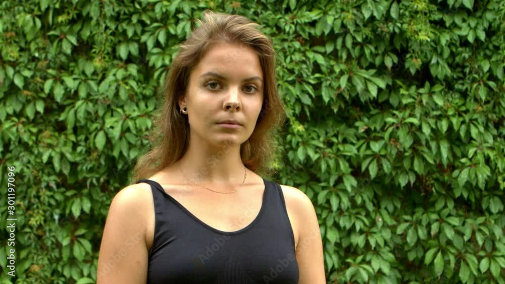 Young model girl with brown hair,looking serious straight into camera. Young model girl with brown hair,looking serious straight into camera.