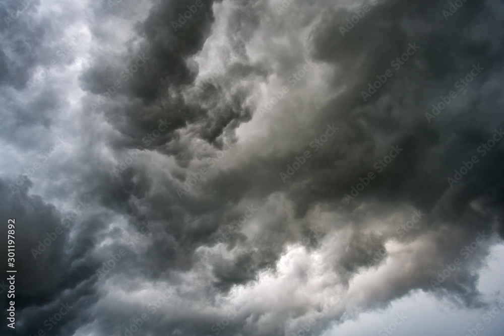 Obraz premium Dark sky and dramatic black cloud before rain.A tropical cyclone is a rapidly rotating storm system characterized by a low-pressure center, a closed low-level atmospheric circulation, strong 