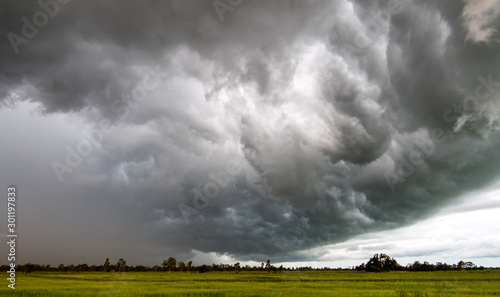 Fototapeta Naklejka Na Ścianę i Meble -  Dark sky and dramatic black cloud before rain.A tropical cyclone is a rapidly rotating storm system characterized by a low-pressure center, a closed low-level atmospheric circulation, strong 