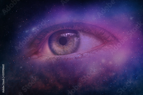 Close up Abstract eye concept looking on a nebula dust in infinite space backgroud. . Mixed media. photo