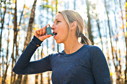 A Fitness running woman in winter season asthma suffer photo