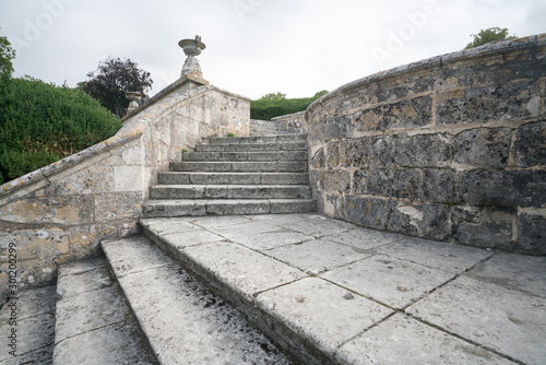 massive old stone stairs leading from one garden into another photo