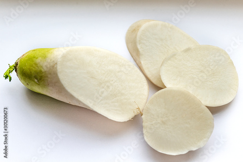 radish cut into pieces on a white background