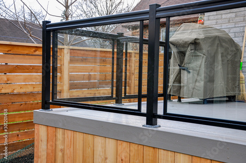A newly constructed backyard deck uses wood composite, cedar skirting and glass and metal railings, while Asian inspired horizontal fencing helps complete the contemporary feel.