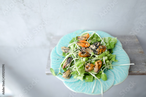 Thai green salad with shrimps on white plate. photo