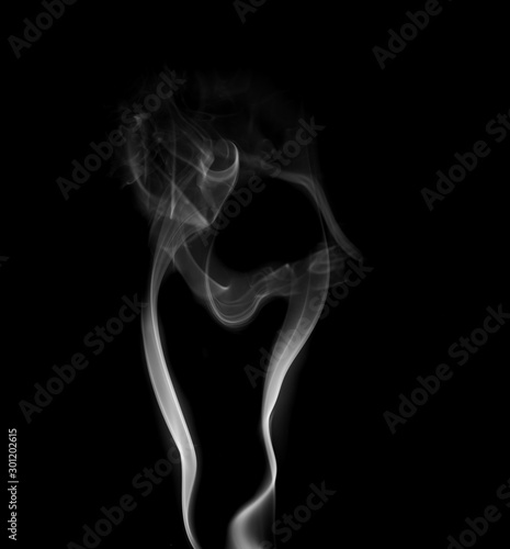 Fototapeta Naklejka Na Ścianę i Meble -  Movement of white smoke isolated on black background.Abstract shape and curve of smoke.